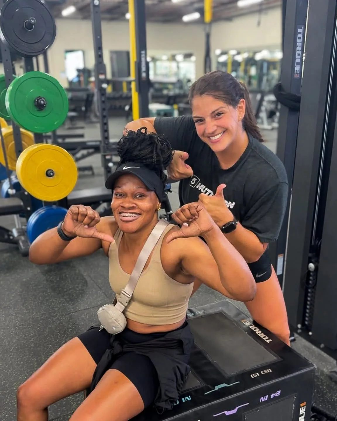 Coach and member celebrating after a bootcamp session