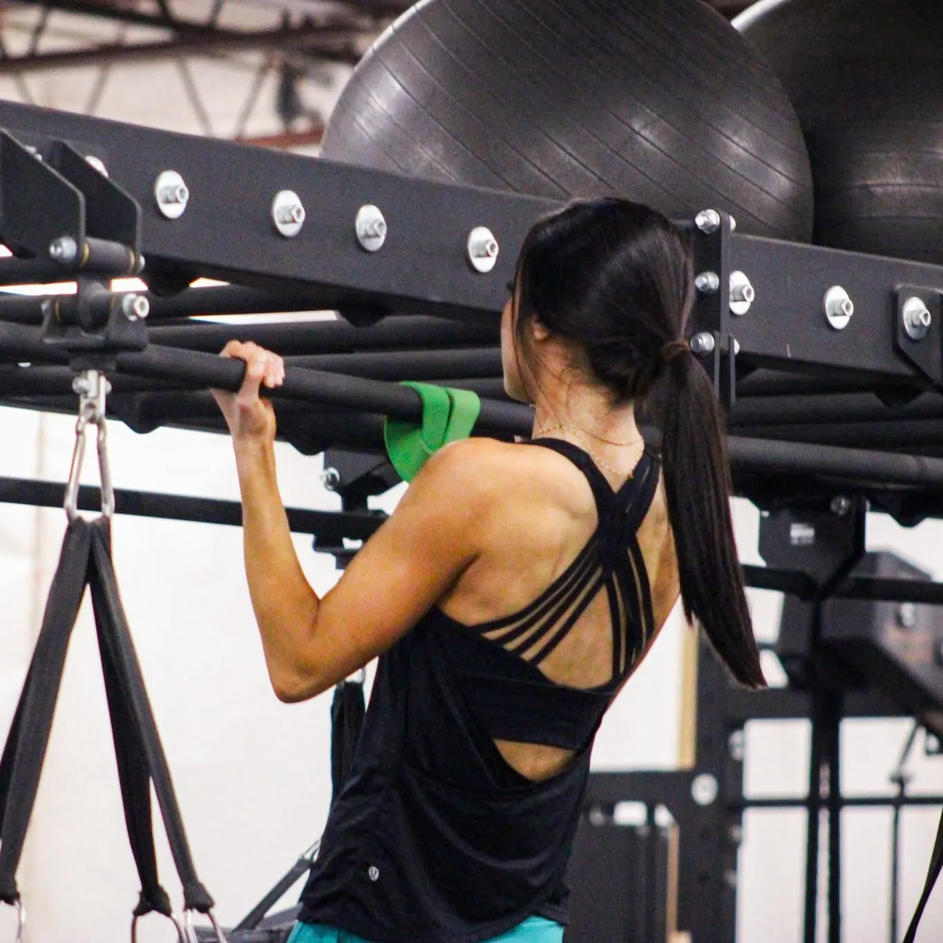 Member gripping the bar on the training rig at Downtown Gym