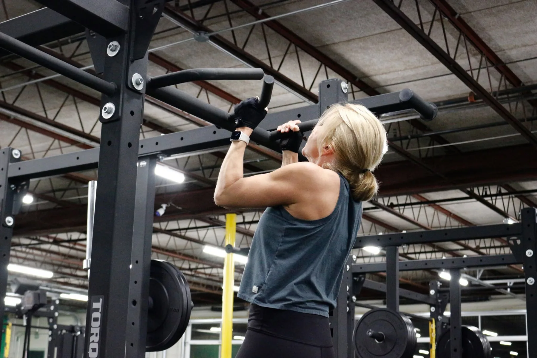 Member doing pull-ups on the rig at Downtown Gym